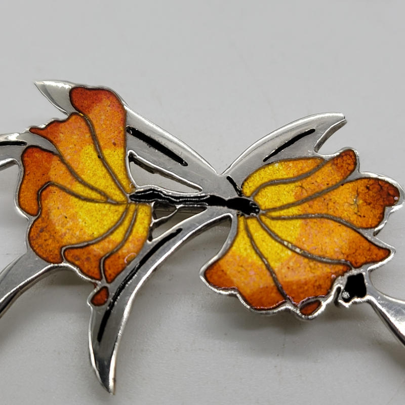 A lovely vivid Shetland Silver enamel and silver brooch in a flower shape. The enamel is a vibrant orange and yellow colour. Fully hallmarked and made by HJAltasteyn Edinburgh 1990. Measures 5cm x 3cm