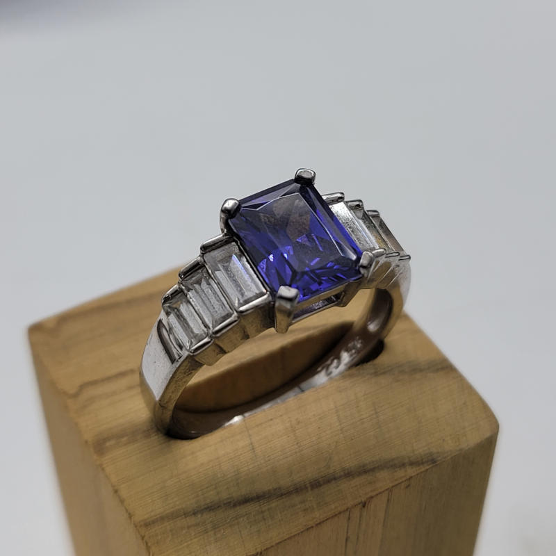 Emerald Cut 1.5K Tanzanite Ring A gorgeous sparkly emerald cut (approximately 1.5K) tanzanite stone with baguette cubic zirconia graduating in size down the shoulders of this beautiful ring. The ring itself is made from 925 silver. The tanzanite measures 6mm x 9mm UK Size R US Size 8½ Circumference 58.5mm