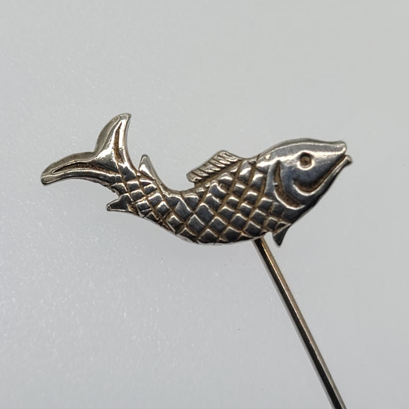 Vintage Orkney Silver Leaping Salmon Lapel Pin This Scottish silver lapel pin is a true work of art with intricate details that capture the beauty and power of the Scottish salmon as it leaps. Crafted from the finest Scottish silver, this pin features a lifelike portrayal of a Scottish salmon in mid-air, its scales gleaming in the light. It is truly individual and would make a stunning addition to any jewellery collection. It is also a wonderful tribute to the majestic salmon that are such an important part of Scottish culture and nature. Measures 2.2cm x 1.5cm with a pin length of 3.8cm