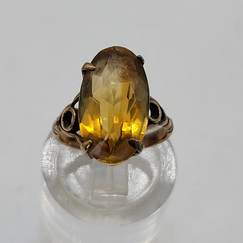 Antique 3K Oval Orange Citrine 9ct Rose Gold Ring A small antique citrine ring approximately 3K in size. The citrine is slightly off centre and is more orange in colour than yellow. The ring is for an extremely small finger. It has an ornate setting constructed from 9ct rose gold and 9ct yellow gold. UK Size G½ US Size 3¼ Circumference 45mm