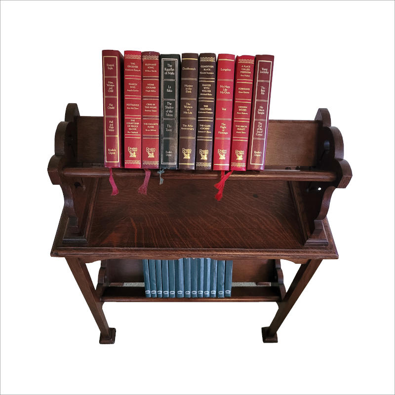 Arts And Crafts Oak Book Trough A floor standing Arts & Crafts book trough made from good quality oak. With cut outs on both sides, this book trough sits sturdily on 4 straight legs with a 2nd trough near the base acting as a sturdy stretcher. Measures 65cm x 29cm x 86cm