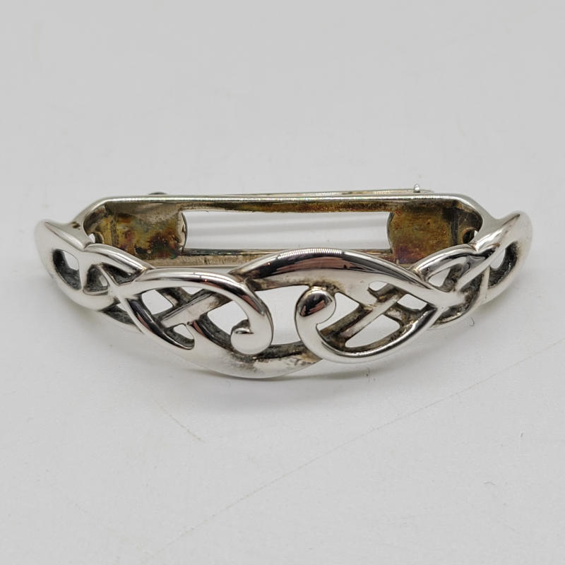 Scottish Silver Scarf Ring by Ola Gorie A curved half moon style 925 silver Celtic scarf ring that has a pin to the rear so it can worn extra securely. Made by Ola Gorie and hallmarked Edinburgh 1989 Measures 45mm x 13mm